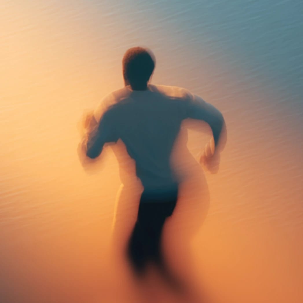 Motion-blurred runner silhouette against a split blue and warm-orange background