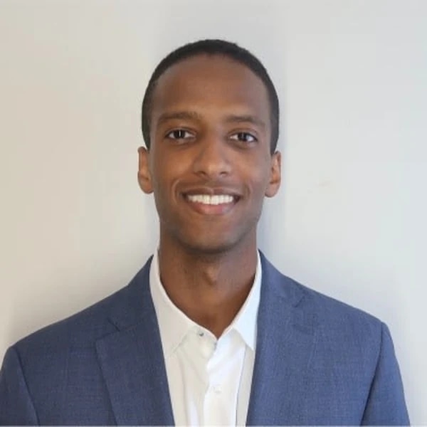 Professional headshot of a smiling man wearing a blue blazer and white shirt.