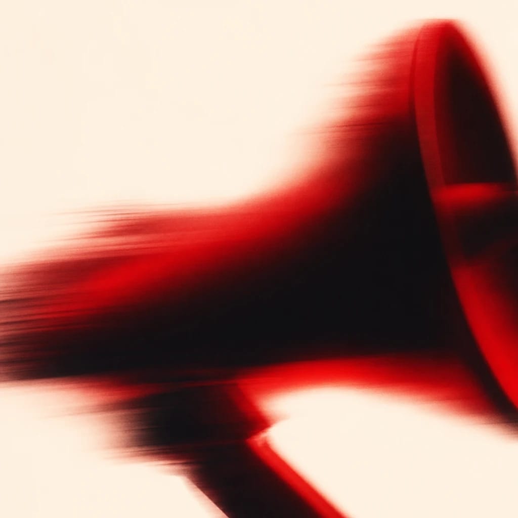 Stylized scene featuring vivid red megaphone on clean surface, rendered in orange, off-white