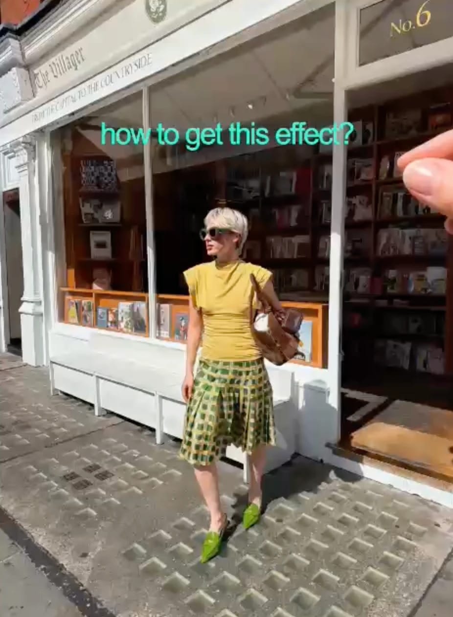 Person posing outside a bookstore as overlaid text asks, “how to get this effect?”.