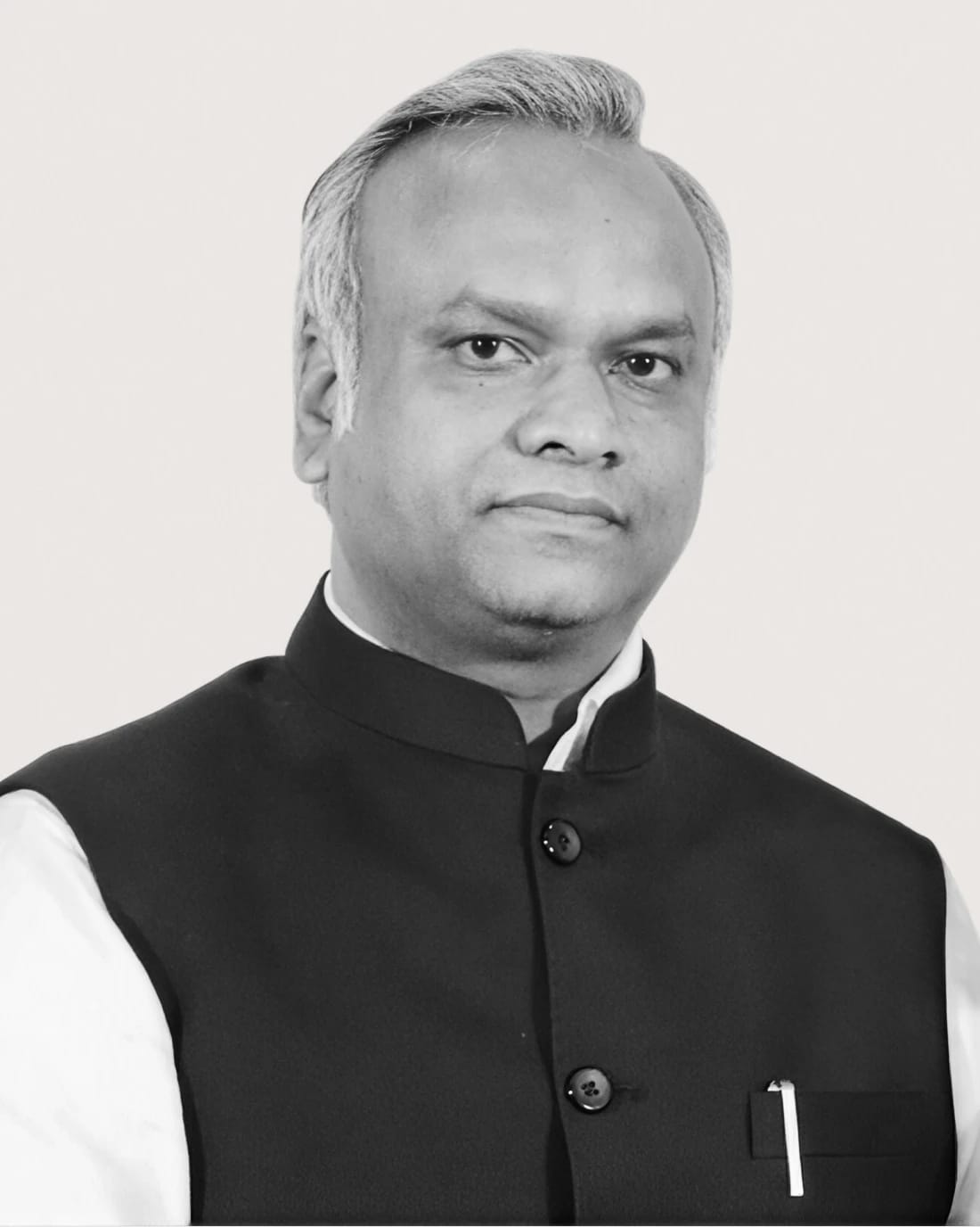 Head-and-shoulders portrait of an unidentified man in a black suit and white shirt.