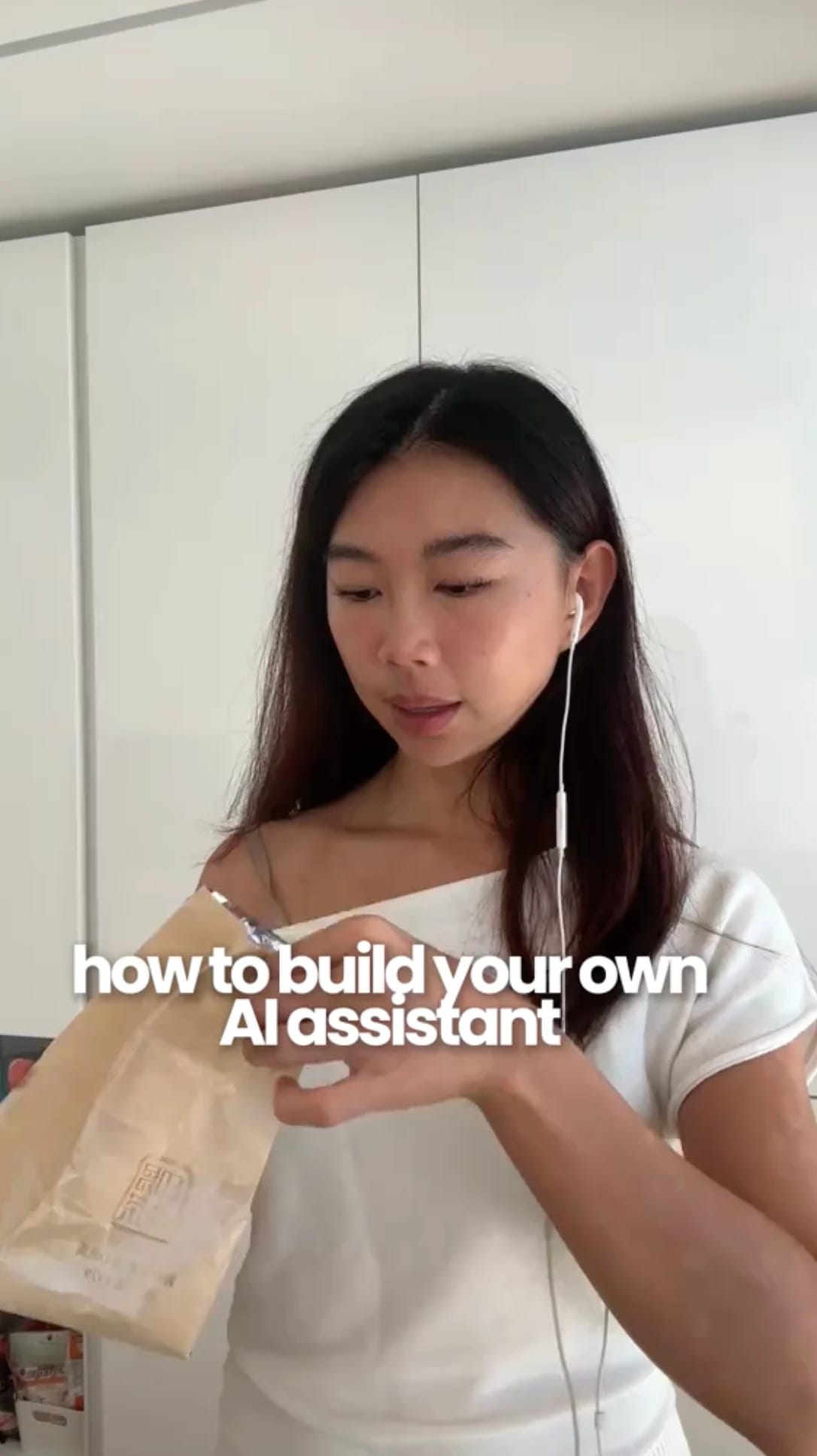 Person holding a bag, wearing earphones, text reads "how to build your own AI assistant."