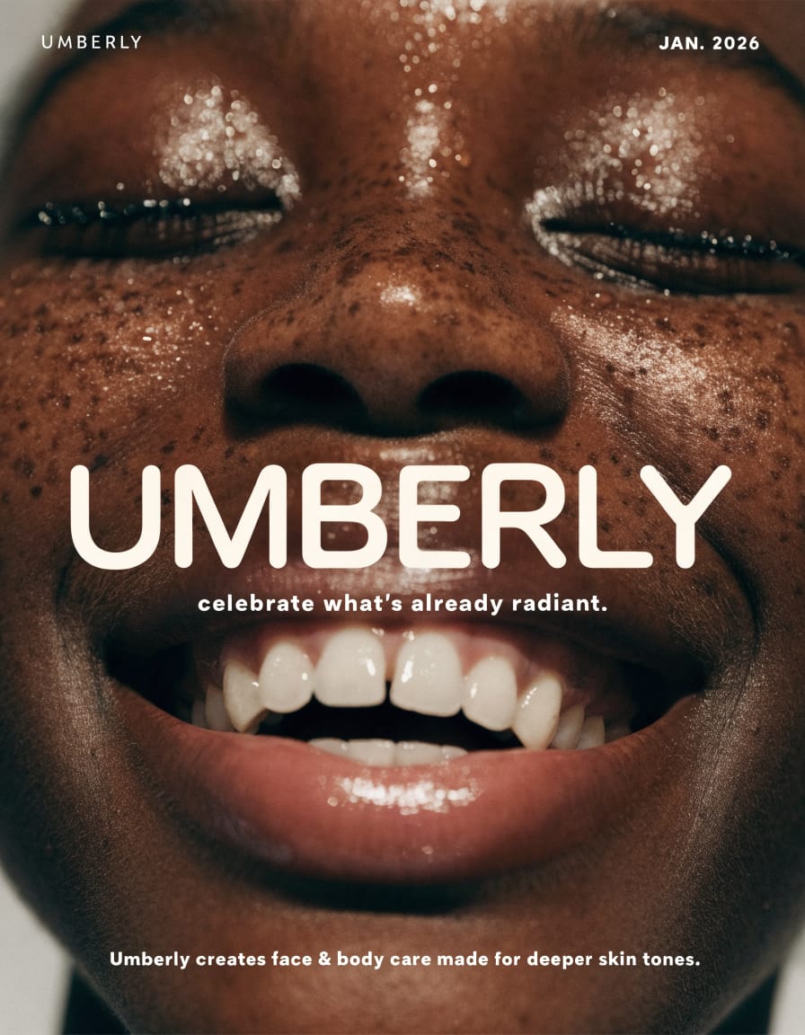 This is a static, close-up advertisement for Umberly skincare, featuring a person with deep skin tones. The overall mood is bright, positive, and radiant, emphasizing natural beauty. The setting is likely a studio, with a simple, light background that highlights the subject's face. The visual style is photorealistic and modern, with a focus on highlighting healthy, glowing skin. The emotional tone is joyful and confident, conveyed through the subject's wide, open-mouthed smile and closed, seemingly blissful eyes. The subject is a person with dark skin, visible freckles, and a radiant, slightly dewy complexion, suggesting moisturized skin. The color palette consists of warm, rich brown skin tones contrasting with the bright white teeth and text, with subtle highlights from the dewy skin.